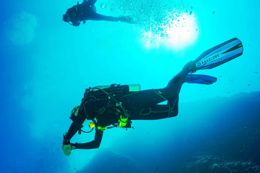 Scuba divers ascending underwater